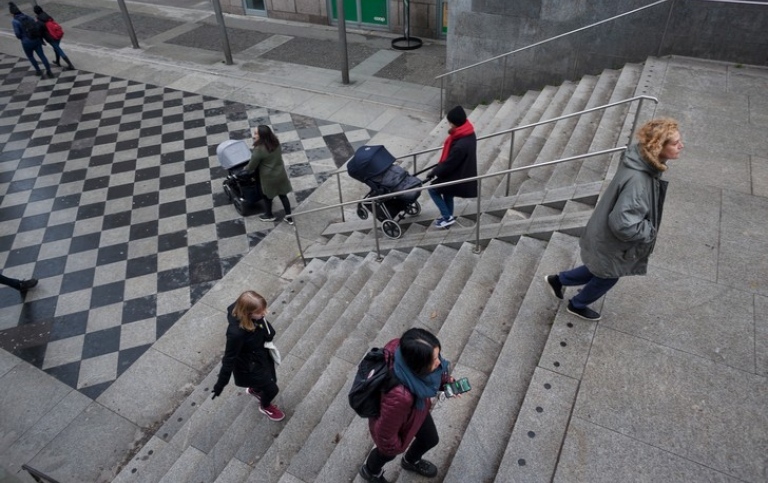 People walking up and down the stairs outdoors.