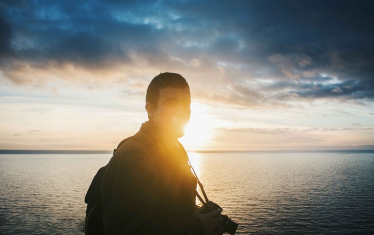 Student with camera in sunset