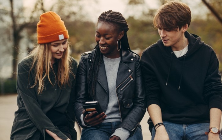 Three students talking to each other.