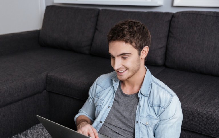 Guy with a laptop at home. Photo: Mostphotos