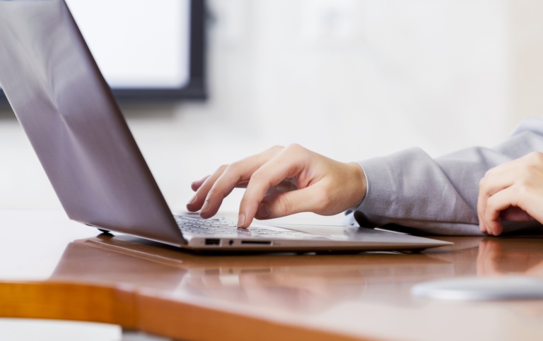 Hands using a laptop. Photo: Mostphotos