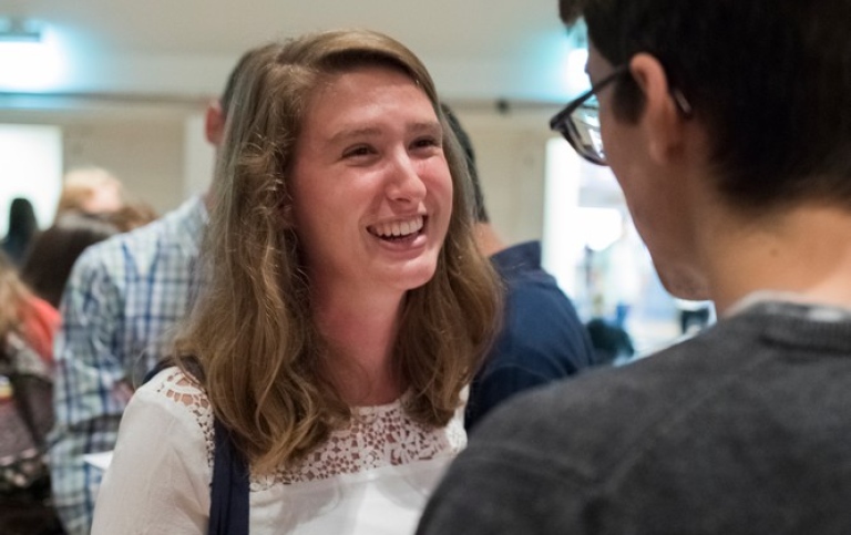 Two young people chatting with each other.