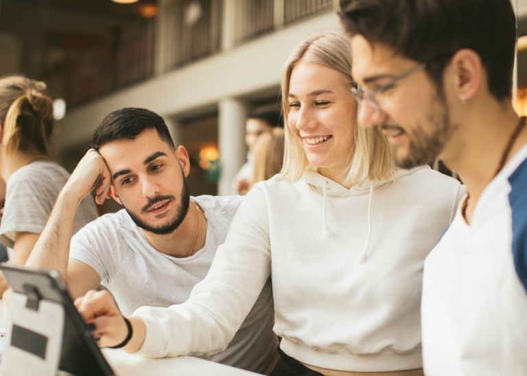 One female and two male students in front of a laptop. Photo: Niklas Björling