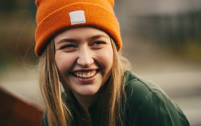 Female student in orange hat smiling. Photo: Viktor Gårdsäter