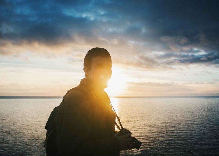 Student with camera in sunset