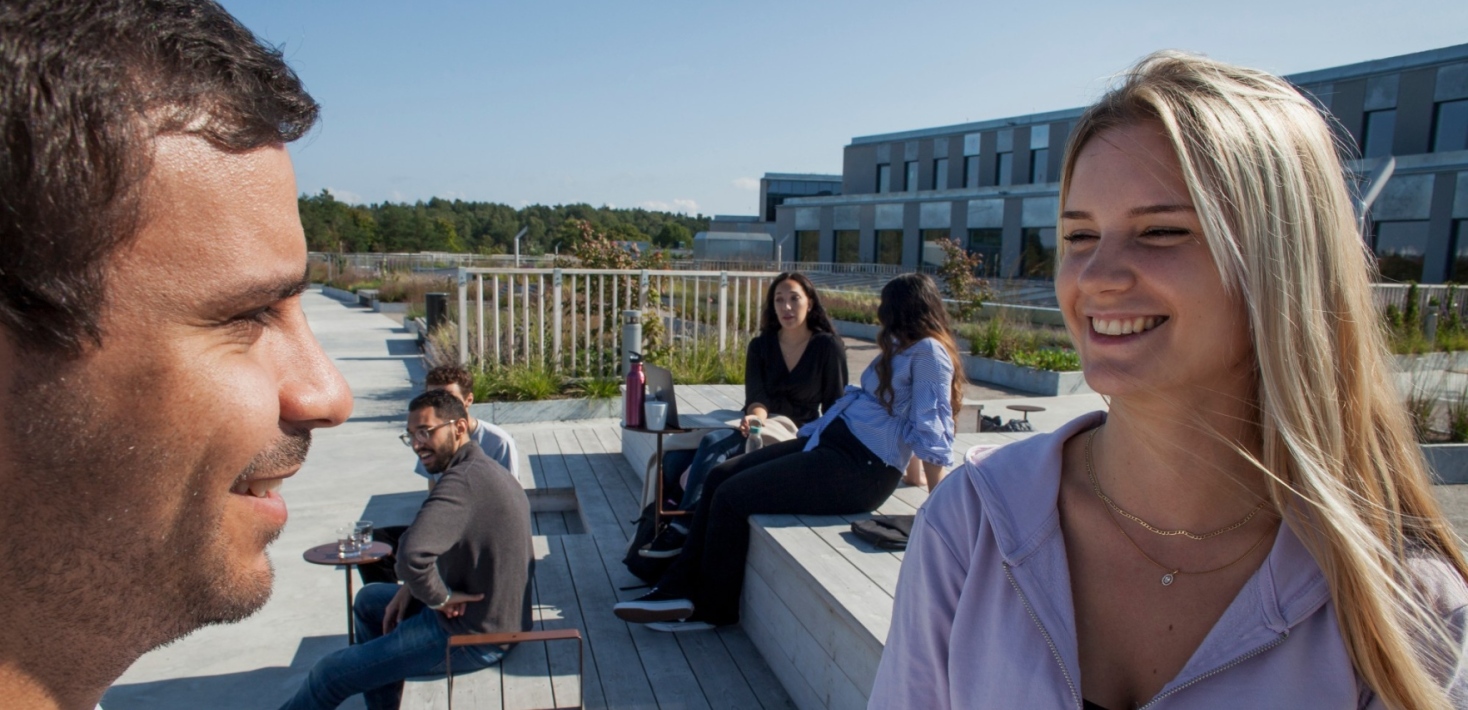 Students on a sunny roof terrace at the Albano campus.